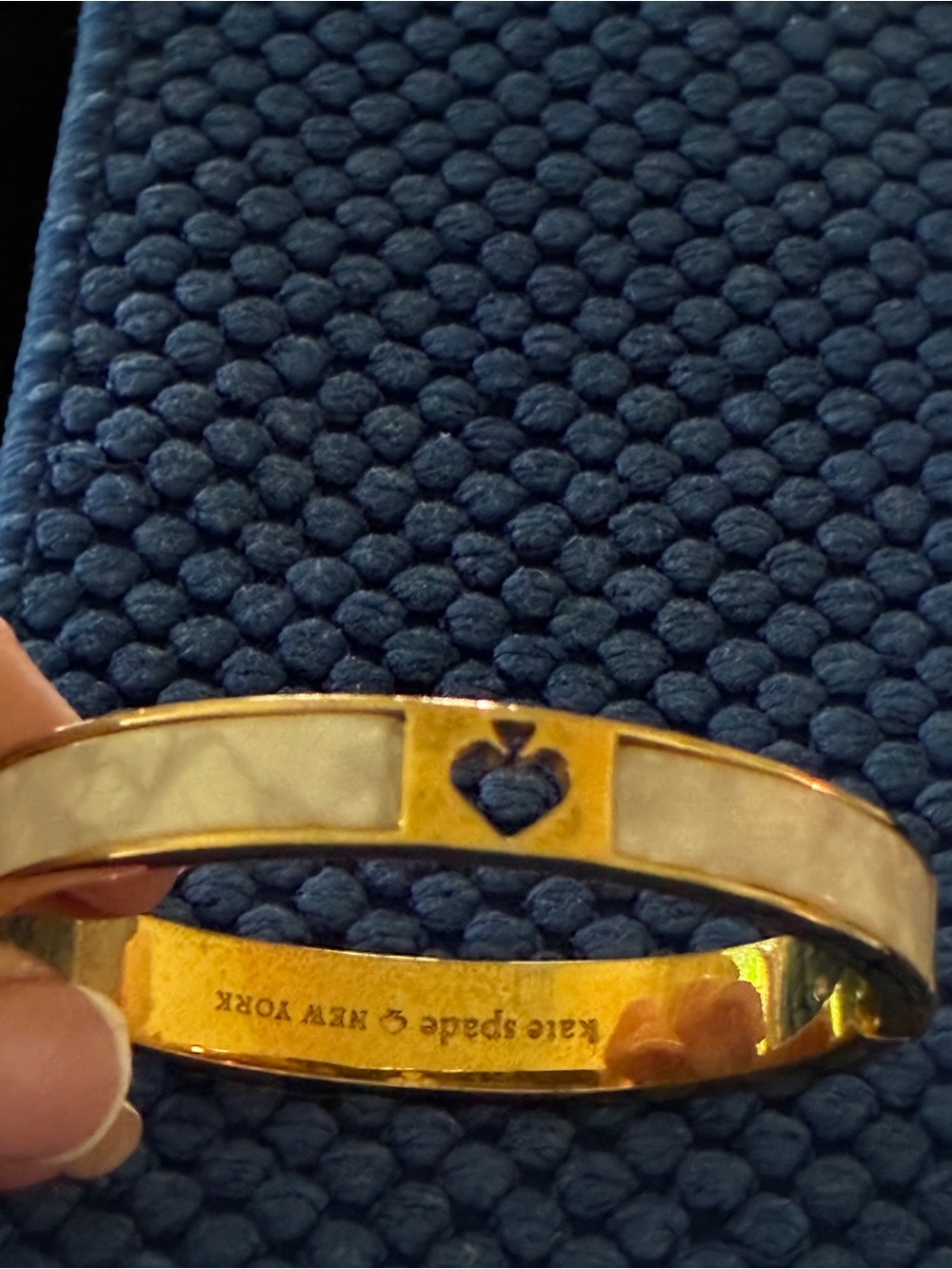Kate Spade gold-tone bangle with cream enamel and heart detail